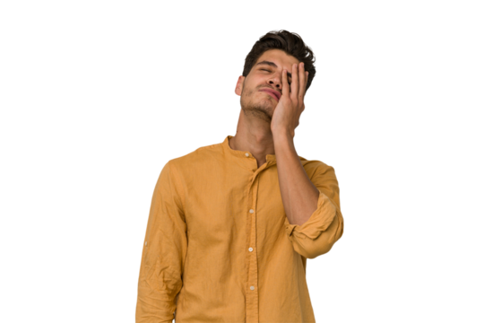 Young handsome caucasian man isolated on white background tired and very sleepy keeping hand on head.