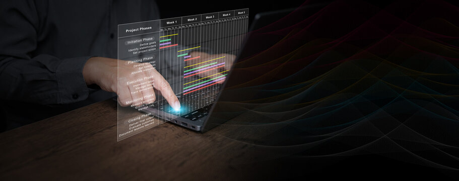 Businessman using laptop to manage project phases with digital Gantt chart interface, showing initiation, planning, execution, monitoring, closing process for business productivity improvement.