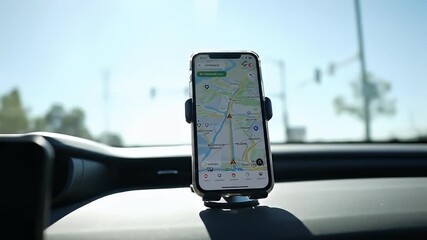 Phone in car mount displaying a navigation app, visible from the car's dashboard - Powered by Adobe