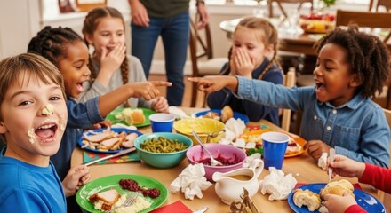 Excited diverse children laughing eating messy holiday meal at dining table indoors during daytime family gathering