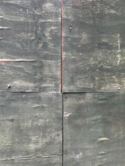 Four weathered wood boards, dark grey patina with doiscolorations from passing time. Rough surface for rustic or industrial background for posters, or digital artwork.