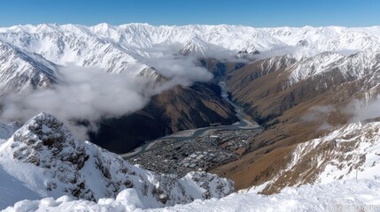Obraz premium Snowcapped mountains provide a breathtaking view of the valley and town below, captured on a clear sunny day in the Southern Alps