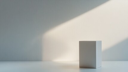 Minimalist composition of a white cube illuminated by soft natural light in a serene indoor space