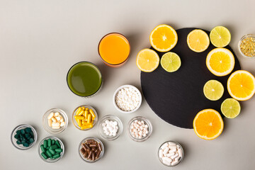 Nutritional supplements, various vitamins and minerals, pills from above on a black stone desk on...