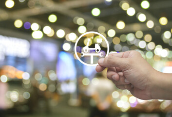 Hand holding service fix motorcycle with wrench tool flat icon in fingers over blur light and shadow of shopping mall, Business repair motorbike service concept