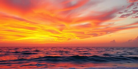 Fototapeta premium Fiery orange and pink sunset paints the sky over tranquil ocean waves, landscape, twilight