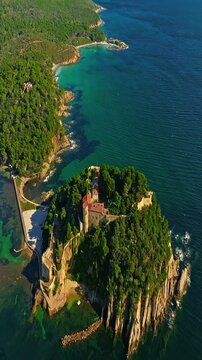  Aerial view of Fort Bregancon sunset aerial view from the mediterranean sea. A yacht is anchored near the fortress