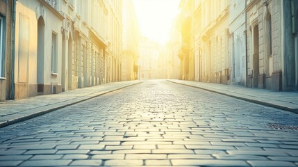 Cobblestone street illuminated by sunrise in a historic European city during early morning hours