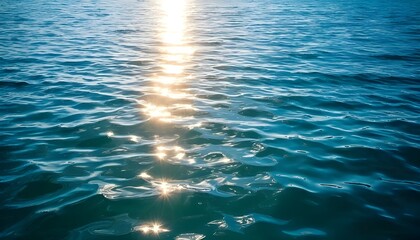 Photo of blue sea water with sunlight reflection