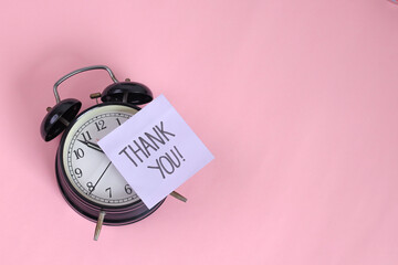 Alarm Clock Featuring Thank You On Sticky Note Over Pink Background