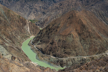 Aerial view of Tiger Leaping Gorge in Yunnan, China. The Jinsha River winding between steep cliffs of Haba and Jade Dragon Snow Mountains, one of the world’s deepest canyons
