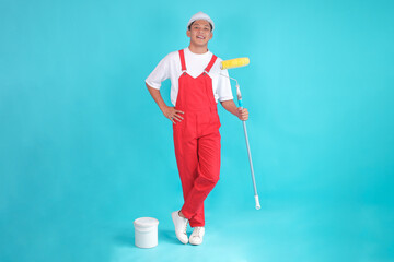 Full Body Confident Young Painter Male Hold Paint Roller with Bucket on Blue Studio Background