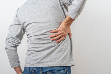 Mature man grabbing his back. Symptoms of pyelonephritis, inflammation, kidney pain in an adult man.