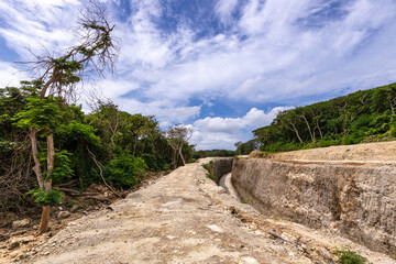 Dirt road with a wall on the side