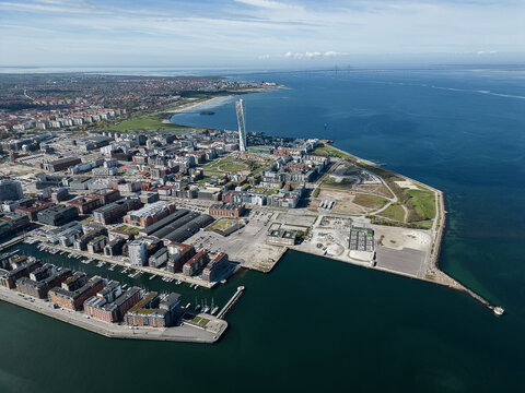 Aerial view of the Turning Torso skyscraper piercing the skyline amidst the urban tapestry where land meets the tranquil sea., Malm&Atilde;&para;, Sk&Atilde;&yen;ne l&Atilde;&curren;n, Sweden.