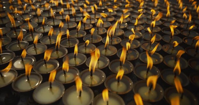 Groups of butter lamps burn brightly as devotees offer prayers at Boudhanath Temple, Nepal. The golden light reflects faith, peace, and the deep spiritual culture of Buddhist devotion
