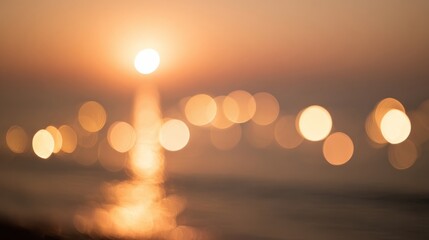 Dreamy sunset over calm sea with soft golden hues, beautiful bokeh effect on water,