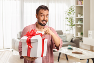 Happy young man opening a gift box