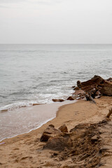 Old rocks on the seaside. Beautiful background of beach water flowing on the rocks.