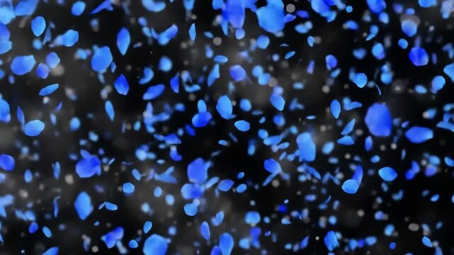 A profusion of vibrant blue flower petals floats gently against a dark backdrop, creating an ethereal and delicate visual effect.