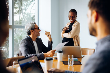 Group discussion around a table featuring business professionals in a meeting