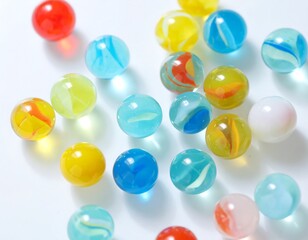 Colorful glass marbles scattered on a white surface