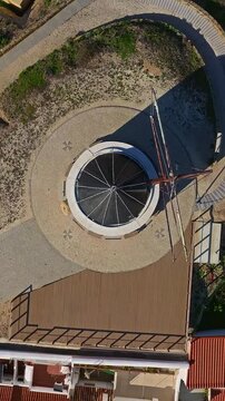  Aerial view of small village with windmill and picturesque rooftops, Odeceixe, Portugal