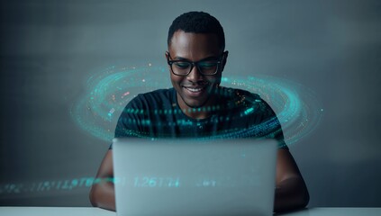 Smiling coder wearing glasses working on laptop at desk in office, with holographic data overlays