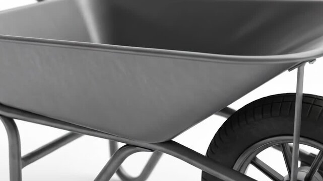 Close-up of a grey metallic wheelbarrow with a black tire and rim on a white background