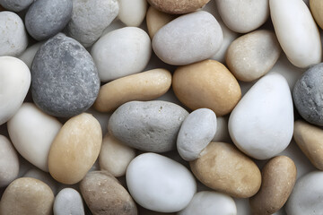 Smooth pebbles in various shades arranged for decorative purposes in a serene setting