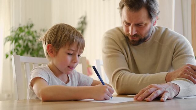 Dad teaches his son writing and counting. Kids primary education. Children learn, study in home school. Daddy male helping teaching little child boy support studying, learning homework. Knowledge day. - Powered by Adobe