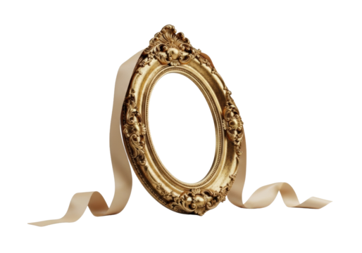 An ornate, oval antique gold picture frame with intricate scrollwork and tarnished gold leaf, elegantly positioned at 45 degrees, beside a delicate, unadorned pale cream silk ribbon, on a clean light