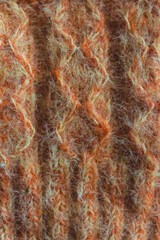 Orange and yellow knitting pattern. Melange knitting wool background. Woven crochet close up. Knitting hobby. Knitwear concept. Needlework background. Mohair socks close up.