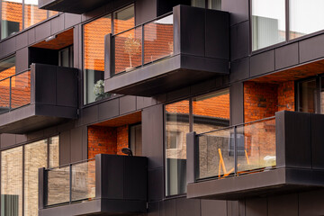 Modern apartments with protruding metal balconies and warm brick tones creating rhythm, depth and urban sophistication in Copenhagen contemporary design