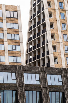 Modern vertical architecture with alternating balconies and metal panels reflecting Scandinavian functionality and contemporary living style in Copenhagen