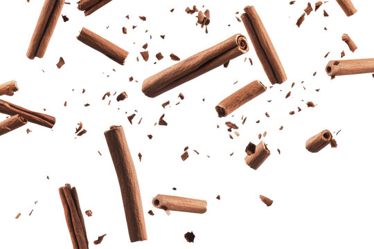Cinnamon sticks falling and floating isolated on transparent background. Falling cinnamon sticks isolated on white background.