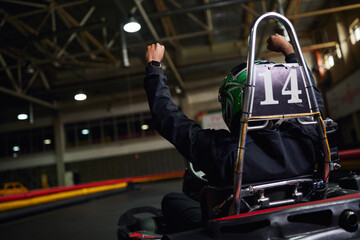 Excitement builds as racers celebrate victory in indoor go karting competition