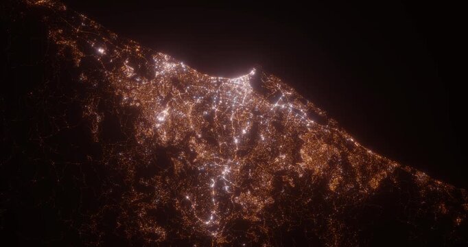 Durban (South Africa) aerial view at night. Top view on modern city with street lights. Camera is zooming out, rotating counterclockwise. Vertical video. The north is on the left side
