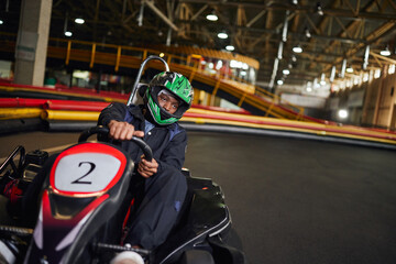 Exciting indoor karting adventure in a vibrant leisure center at sunset