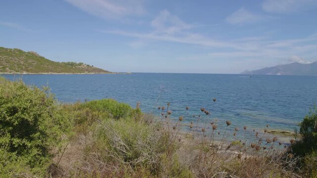 Saint-Florent Corsica coast sunny view of crystal clear turquoise waters untouched natural beauty northern Corsican seaside rocky shorelines under a bright blue sky serene Mediterranean landscape
