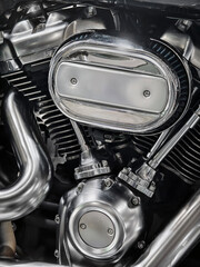 Fototapeta premium Close look at a polished motorcycle engine part showcasing intricate design and detail in a garage setting