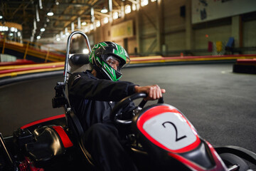Excitement of indoor go kart racing during leisure time at a vibrant track © LIGHTFIELD STUDIOS