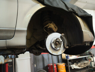 Car brake disc and pad closeup after replacement in auto repair garage