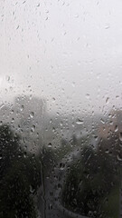Rain Spattered Window Overlooking Blurred Cityscape