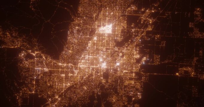 Tucson (Arizona, USA) aerial view at night. Top view on modern city with street lights. Camera is zooming out, rotating clockwise. Vertical video. The north is on the left side
