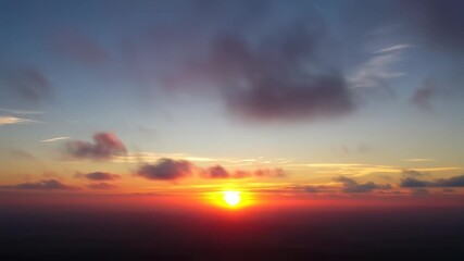 A vibrant sunset sky filled with colorful clouds - Powered by Adobe