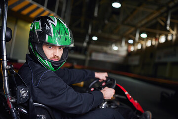 Speeding through the excitement of indoor go karting with friends during leisure time
