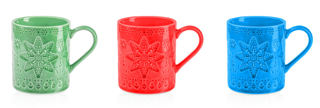 Colorful ceramic mugs in green, red, and blue with embossed snowflake patterns, festive Christmas drinkware set isolated on white background