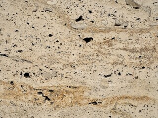 Warm travertine texture with golden veins and natural porous pattern, detailed stone surface ideal for architectural design, wall backgrounds or 3D materials.