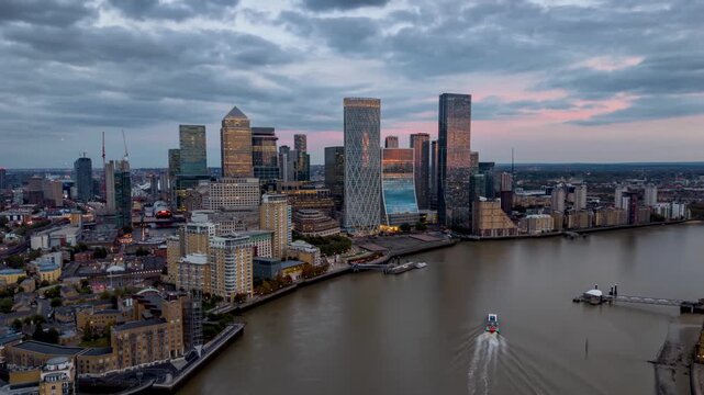 Aerial hyper time lapse view of the financial district Canary Wharf in London with the skyscrapers of banks and insurance companies during dusk